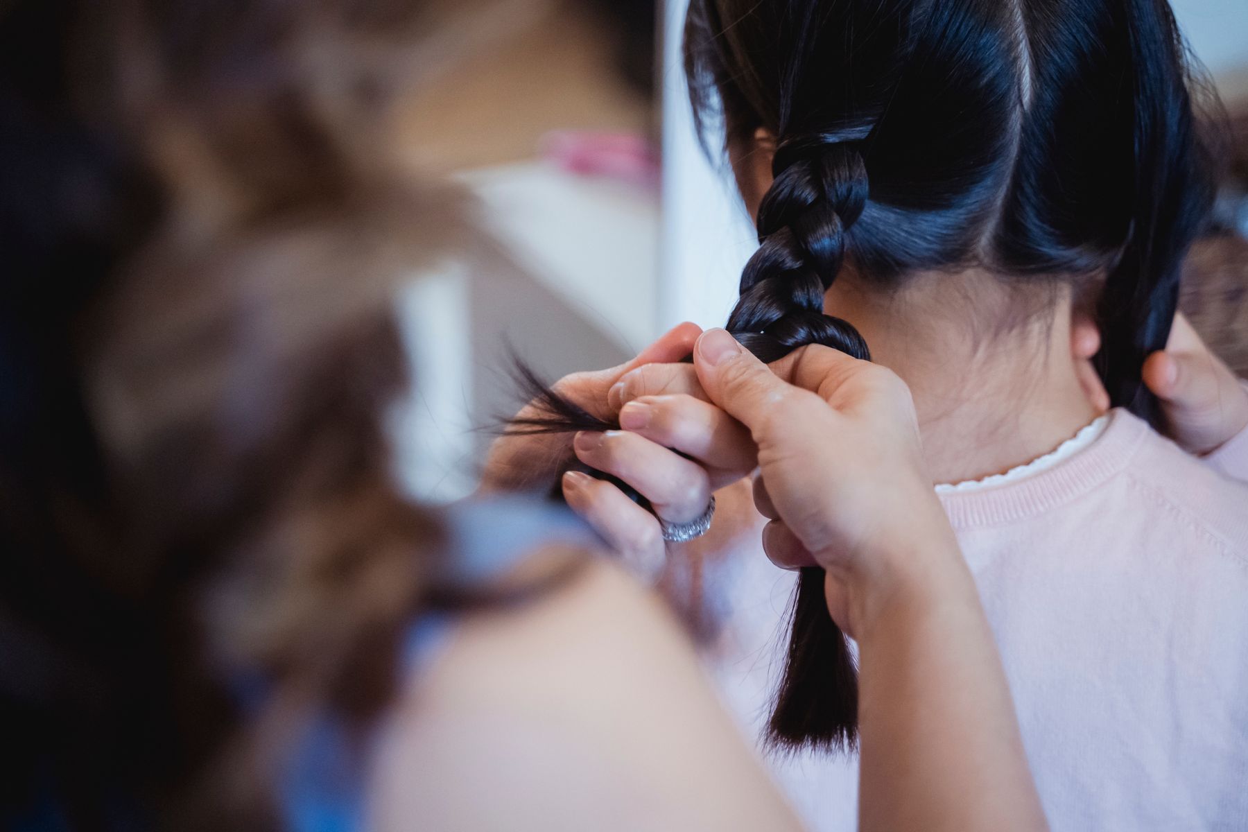 Close-up of hands braiding hair